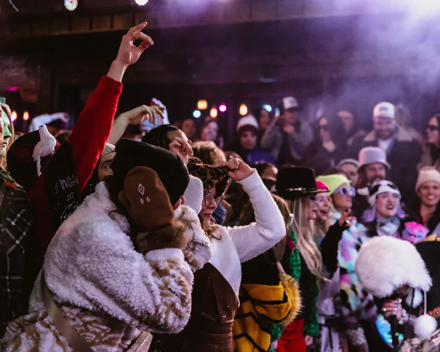 Fireside attendees in winter coats inside the venue